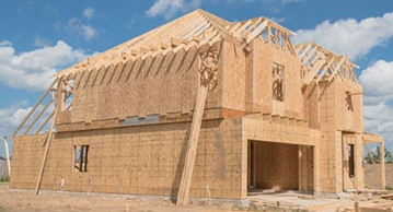 Traditional stick framed house two story with roof trusses.