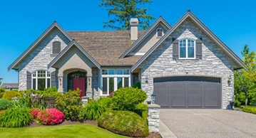 Traditional stick built cape cod house with brick exterior and speciality windows.