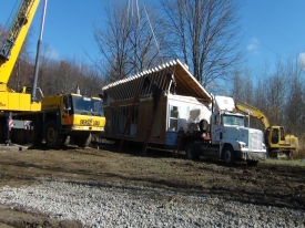 crane lifting roof on house photo